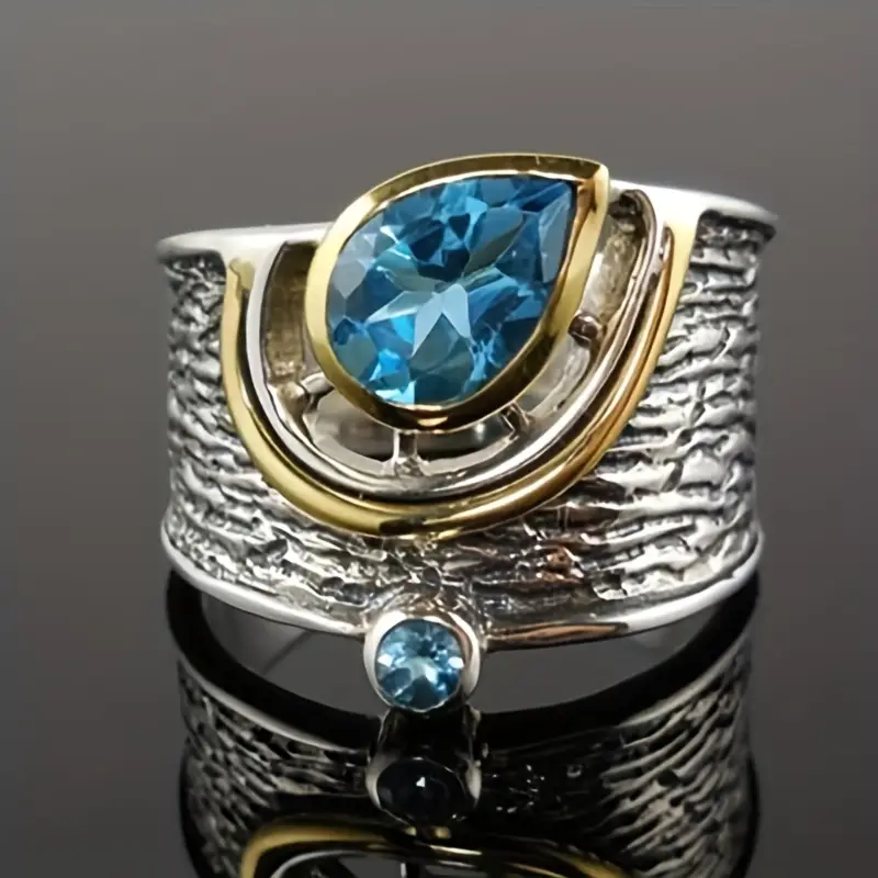 Bague en argent et or avec des cristaux bleus